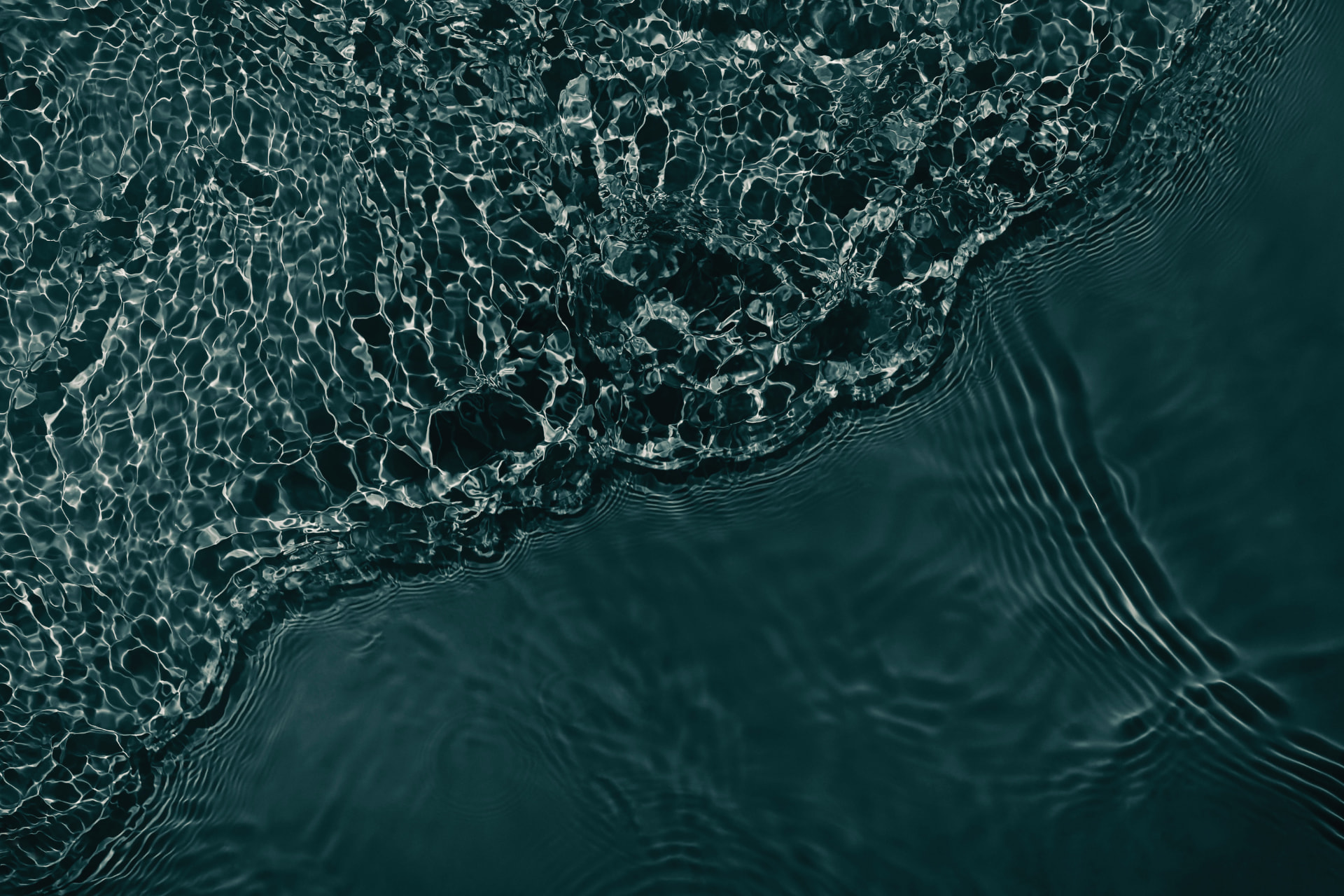 Rippling dark green water surface
