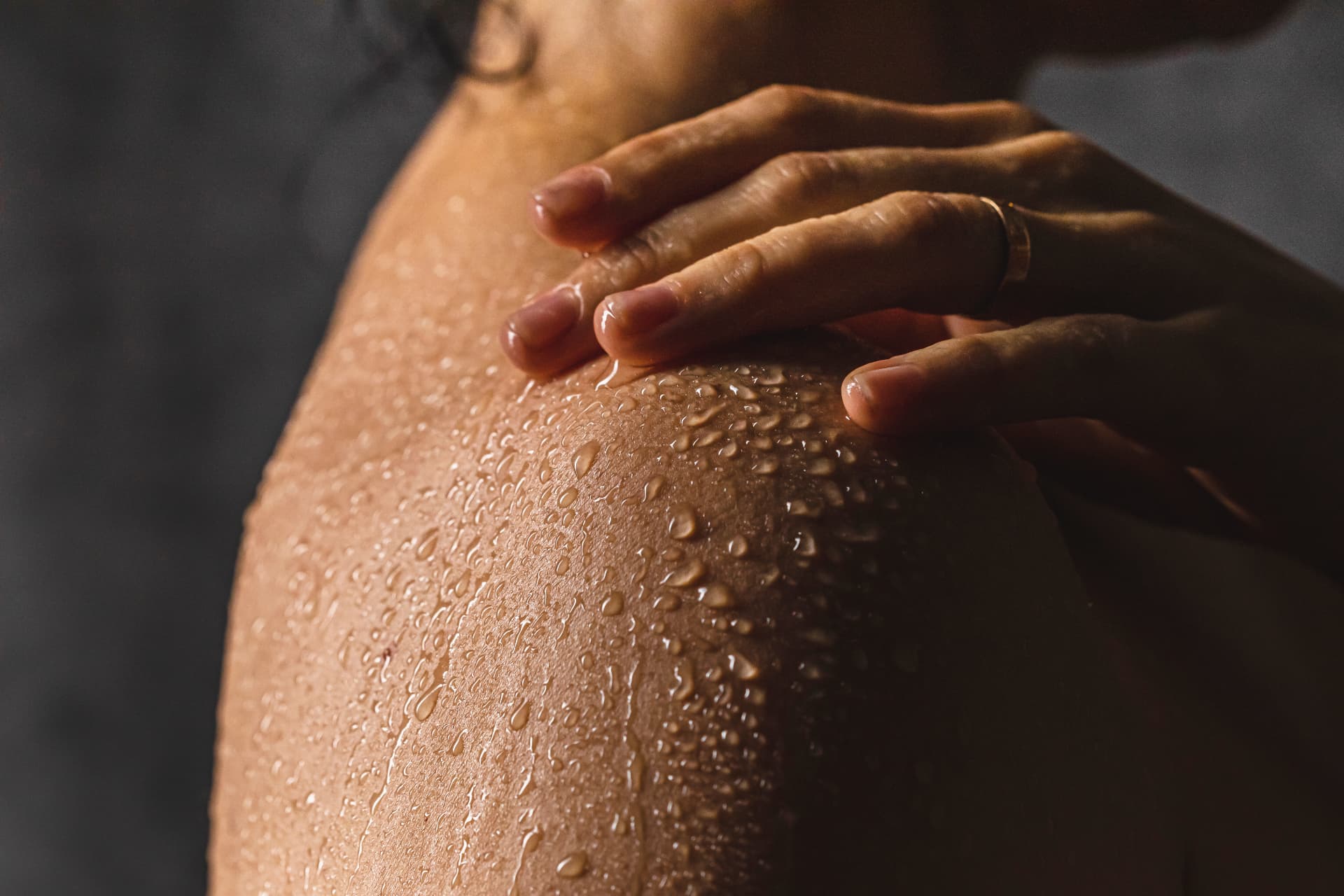 Water droplets on softly lit skin