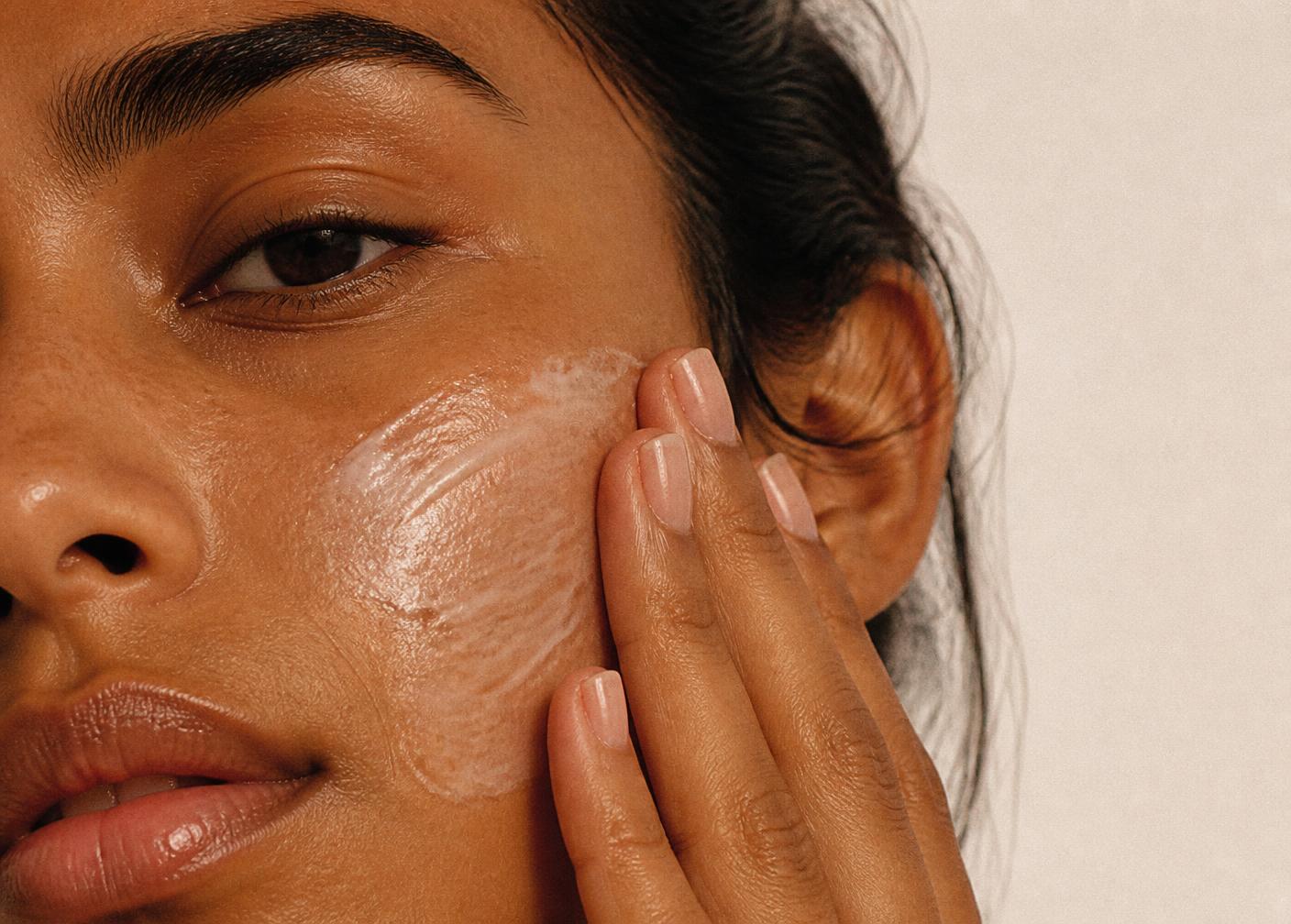 Moisturiser being pressed into the cheek